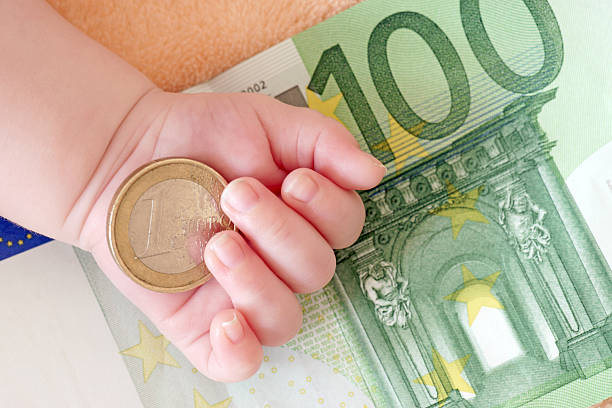 hand of a baby with euro banknotes