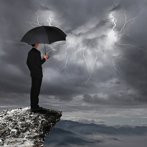istock Business Man with umbrella look rainstorm cloud 451664339