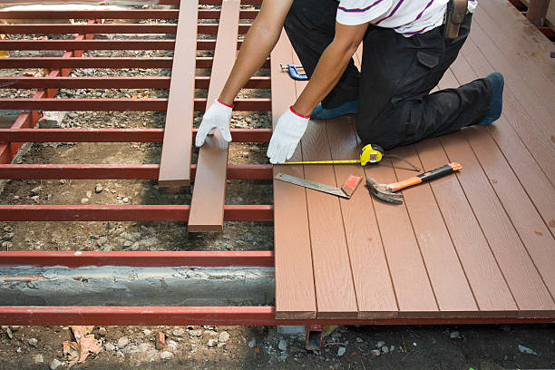 Worker installing wood floor for patio Worker installing wood floor for patio in construction site. deck stock pictures, royalty-free photos & images