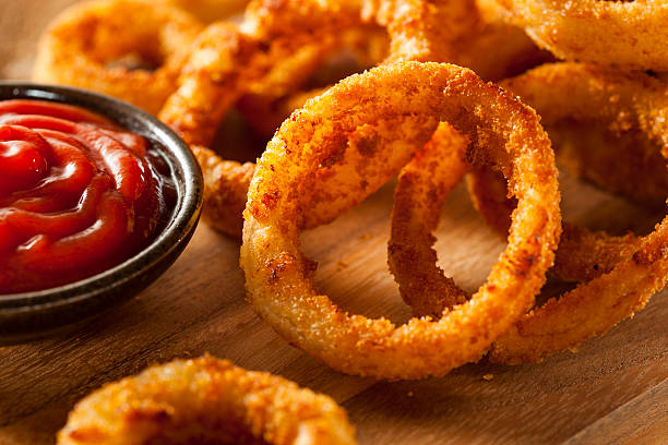 Homemade Crunchy Fried Onion Rings Homemade Crunchy Fried Onion Rings with Ketchup fried onion rings stock pictures, royalty-free photos & images