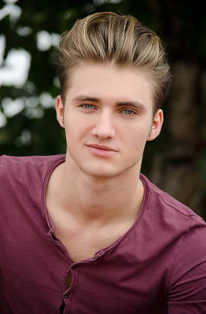 istock Handsome blond young man head-shot outside 451683121