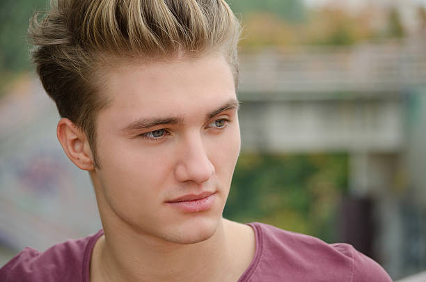istock Handsome blond young man head-shot outside 451683125