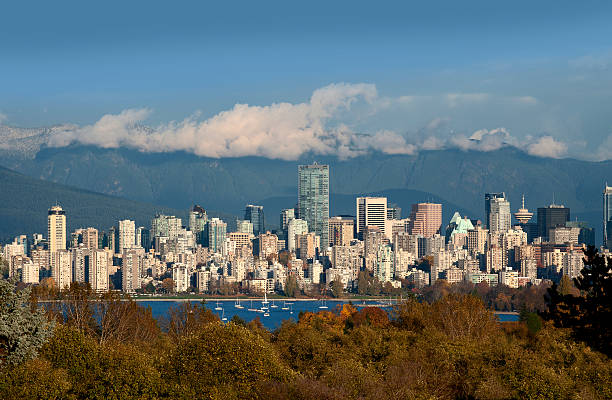 Vancouver Vancouver - skyline with Coast Mountains and English Bay beach english bay vancouver skyline stock pictures, royalty-free photos & images