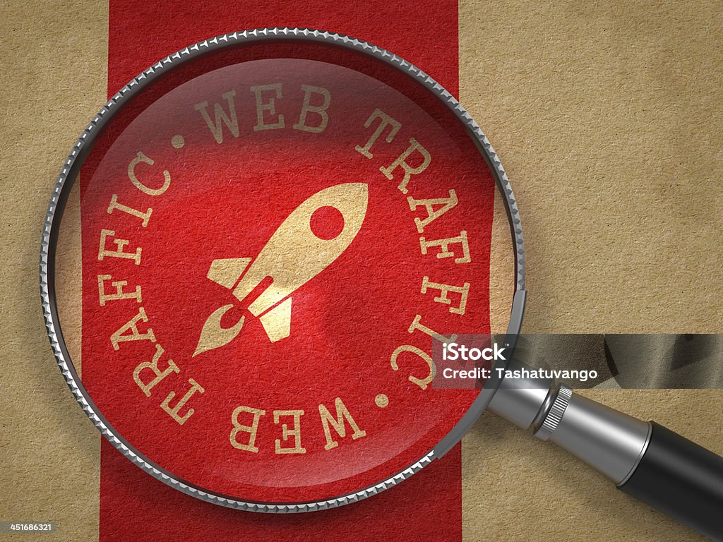 Magnifying Glass with Web Traffic Concept. Magnifying Glass with Web Traffic Written Arround Icon of Go Up Rocket on Old Paper with Red Vertical Line Background. Internet Concept. Growth Stock Photo