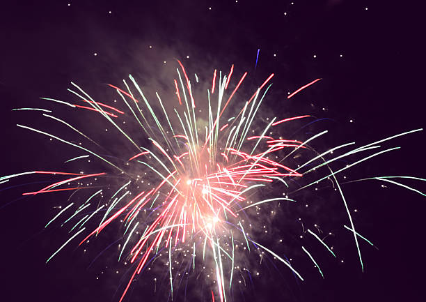 istock holiday fireworks in night sky 451690395