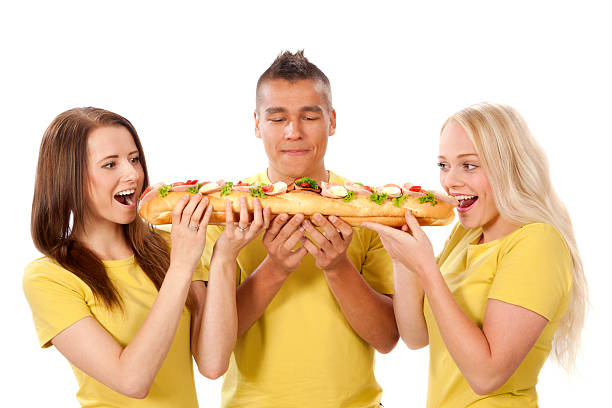 istock Group of young people eating sandwich 451784047