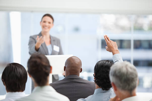 istock Businesswoman gesturing towards her co-worker who has his arm ra 451784607
