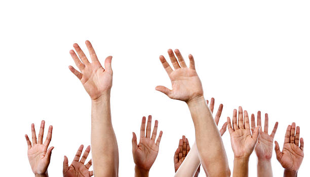 istock Many hands raised in response: volunteering, responding or seeking attention 451787533