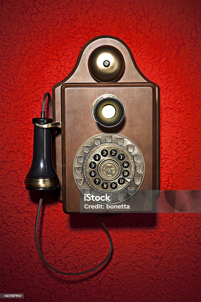 pay phone An old fashioned pay phone against a red background Antique Stock Photo