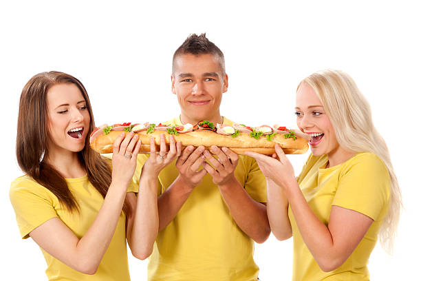istock Group of young people eating sandwich 451795707