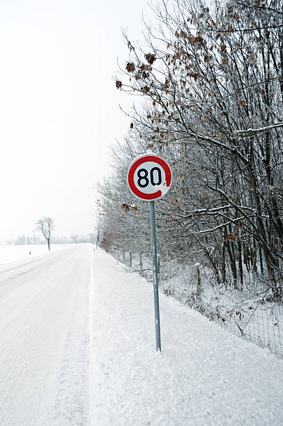 istock snowy road in winter with tree 451800305