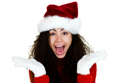 Excited curly haired woman wearing a Santa hat 