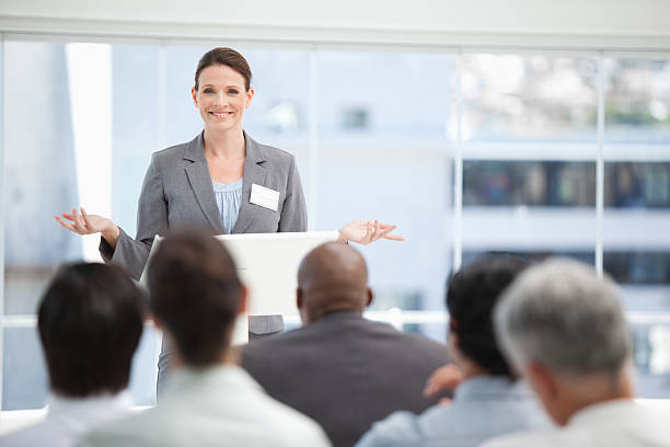 istock Serious businesswoman gesturing with both hands while her collea 451803555