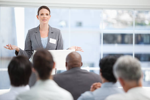 istock Serious business woman gesturing while the colleagues watch her 451803575