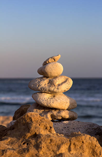 istock Stones stacked with sea in the background 451820617