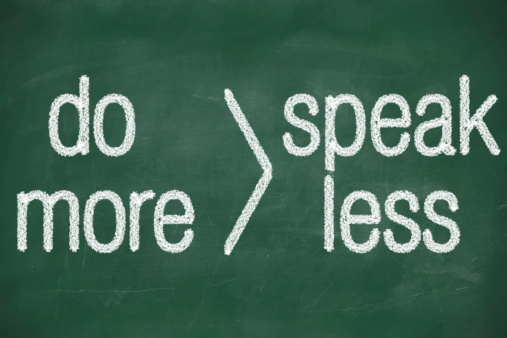 phrase speak less do more handwritten on blackboard