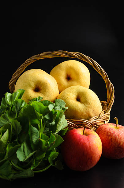 istock Apple and Asiatic in basket on black background 451828615