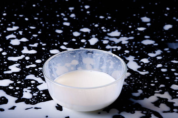 istock pouring a glass of milk creating splash 451828637