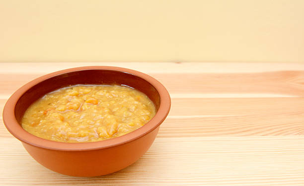 istock Bowl of vegetable soup on a wooden table 451830027