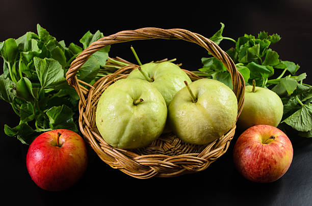 istock Guava and Asiatic in the basket on black background 451831409