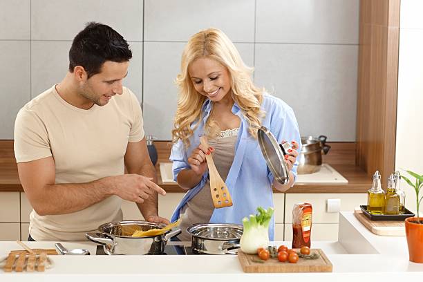 istock Happy couple cooking in kitchen 451834741