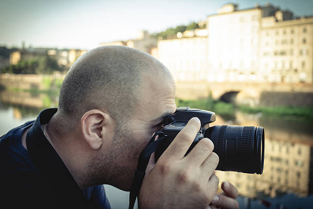 istock Young photographer shooting at dawn in Florence 451838951