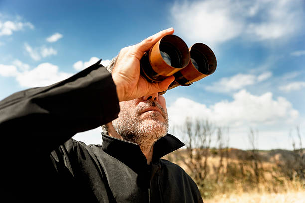 Man with  binoculars stock photo