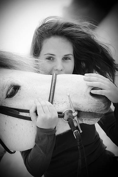 istock Woman playing with her horse 451845715