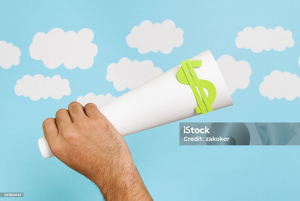 Hand holding rolled paper with dollar sign Stock market launch concept Advertisement Stock Photo