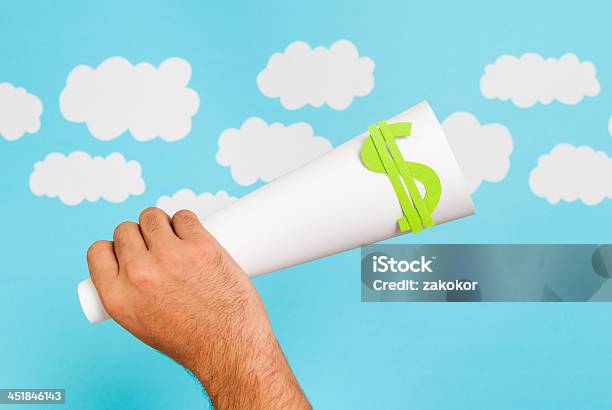 Hand Holding Rolled Paper With Dollar Sign Stock Photo - Download Image Now - Advertisement, Advice, Amplifier