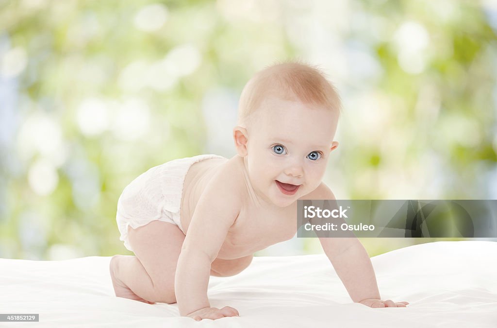 Cute baby with beautiful blue eyes on the nature background Baby - Human Age Stock Photo