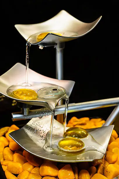 Photo of metal tabletop waterfall on a black background