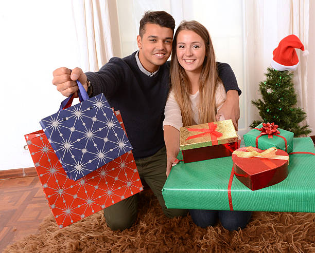 istock Young Happy Couple holding Christmas Presents 451854723