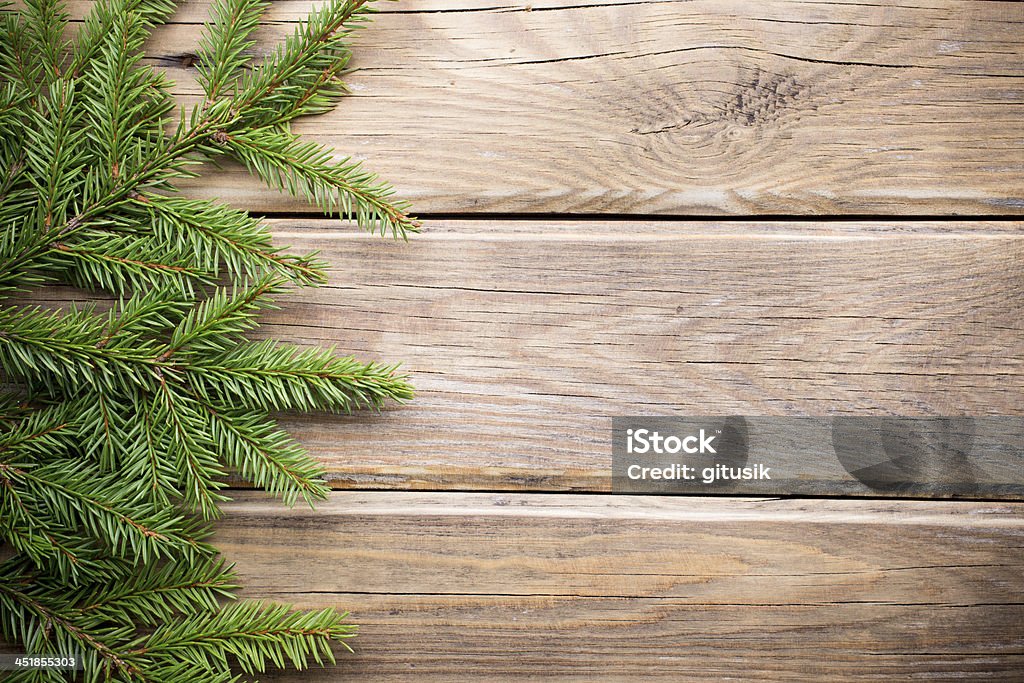 Christmas greeting card. Spruce twigs on a wooden background. Border - Frame Stock Photo