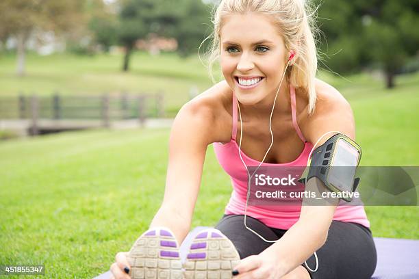 Young Woman Stretching At Park Stock Photo - Download Image Now - 20-24 Years, 20-29 Years, Active Lifestyle