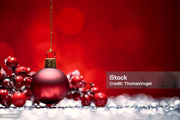 Red Christmas Bauble Glitter Bokeh Hanging Stock Photo - Download Image Now - Red, Christmas, Christmas Ornament