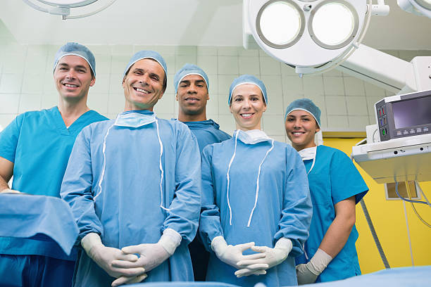 istock Team of surgeons smiling in an operating theater 451860267
