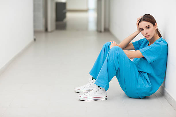 istock Female surgeon sitting on the ground 451860335