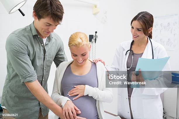 Doctor With A Pregnant Woman And Her Husband Stock Photo - Download Image Now - 20-29 Years, 30-39 Years, Adult