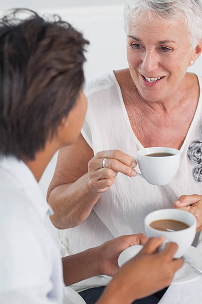 istock Mature friends talking and having tea 451860709