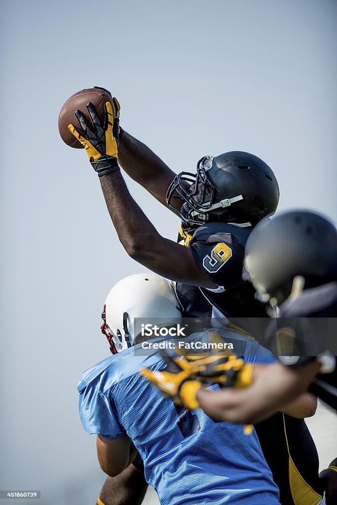American Football Players American football players on the field in action. American Football - Ball Stock Photo