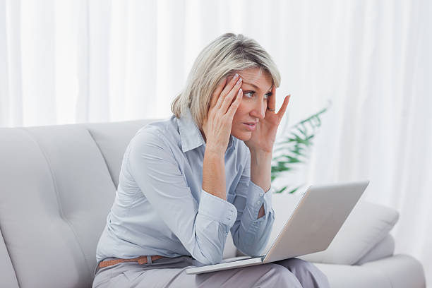 istock Worried blonde woman using her laptop 451860909