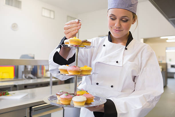 istock Pastry chef holding a tiered cake tray 451861061