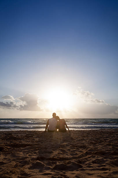 istock Fit couple watching a sunrise at the beach 451862959