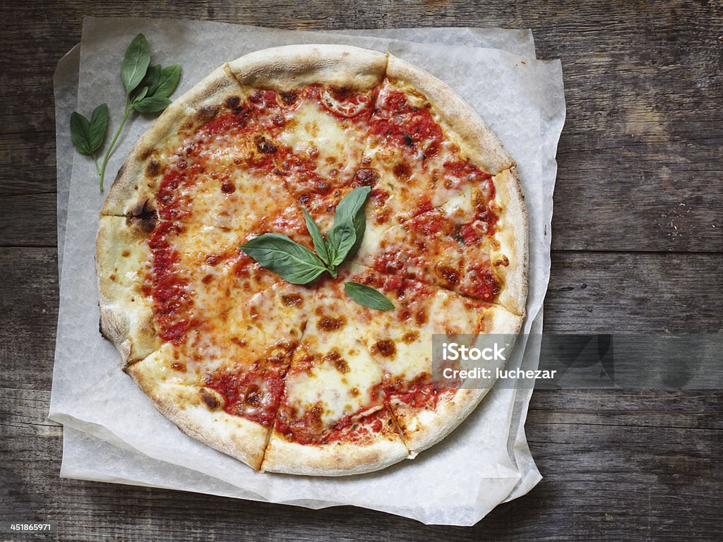 Margherita Pizza Domestic classic italian pizza margherita with tomatoes sauce, mozzarella and basil on a table. Pizza Margherita Stock Photo