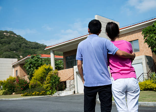 istock couple in front of new home 451870485