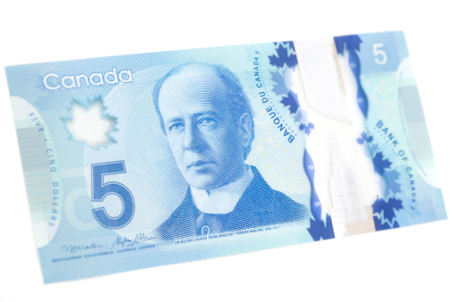 Angle Front of the new Canadian 5 dollar bill, released into circulation Nov 7th 2013. Made from a polymer of biaxially-oriented polypropylene (BOPP) it makes the bills more durable and harder to counterfeit. The front depicts Canada's 7th Prime Minister Sir Henri Charles Wilfrid Laurier.