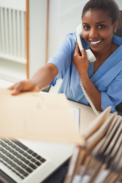 istock Nurse on the phone giving an envelope 451877365