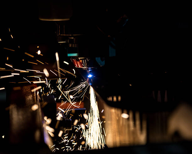 Laser cutting metal with sparks stock photo