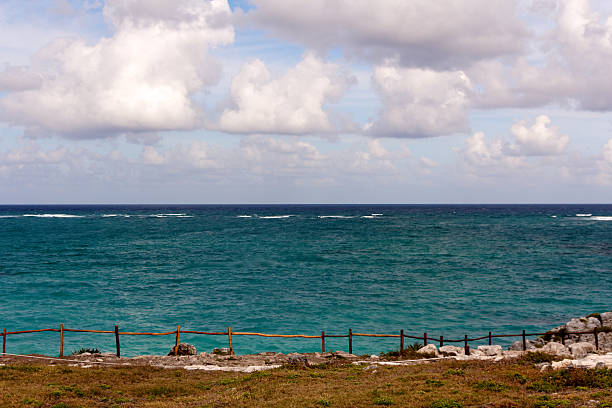 view from cliff на горизонт на tulum - beach bench caribbean sea cloudscape стоковые фото и изображения